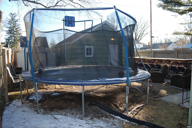 exterior space featuring a fenced backyard and a trampoline