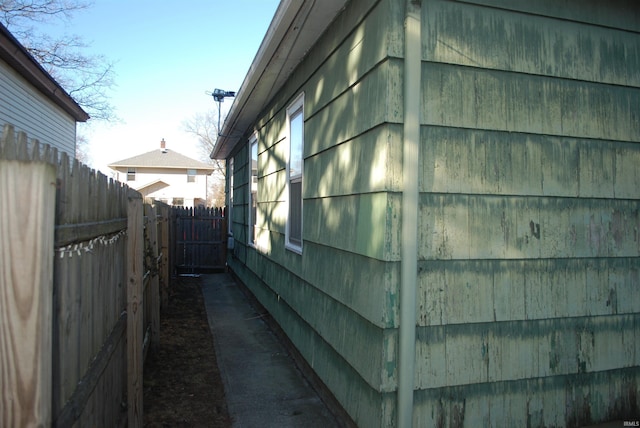 view of side of home featuring fence