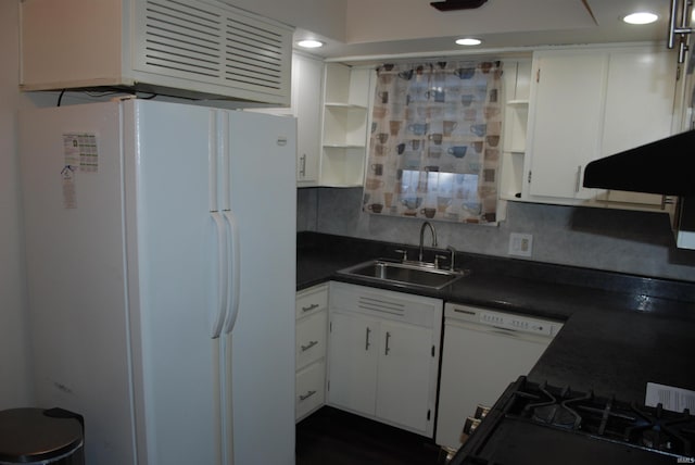 kitchen featuring dark countertops, white appliances, a sink, and open shelves