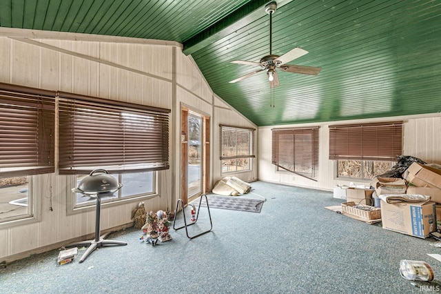 interior space with vaulted ceiling with beams and ceiling fan