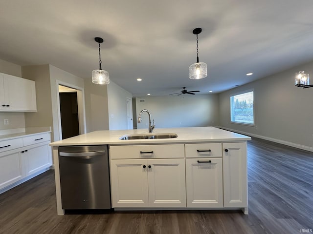 kitchen with a sink, dark wood-style floors, light countertops, and dishwasher