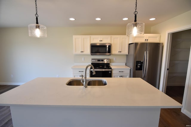 kitchen featuring recessed lighting, stainless steel appliances, a sink, white cabinets, and light countertops