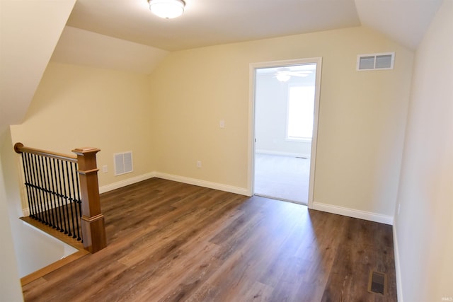 bonus room featuring lofted ceiling, visible vents, and dark wood finished floors