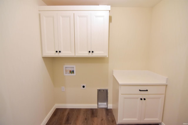 clothes washing area featuring hookup for a washing machine, hookup for an electric dryer, dark wood-type flooring, baseboards, and cabinet space