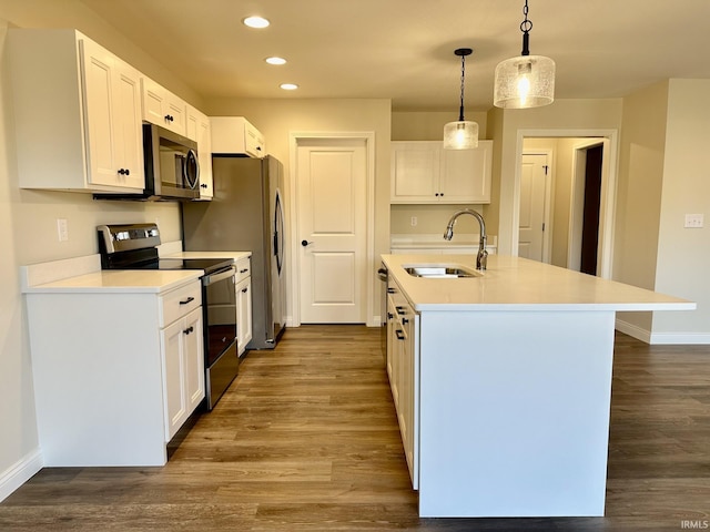 kitchen featuring dark wood-style flooring, stainless steel appliances, recessed lighting, white cabinetry, and a sink