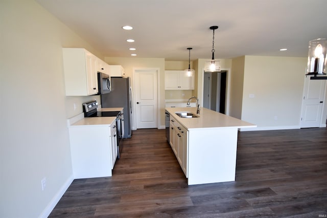 kitchen featuring stainless steel appliances, pendant lighting, dark wood-type flooring, and a sink