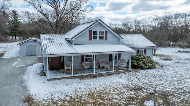 view of front of property featuring an outbuilding, metal roof, and a shed