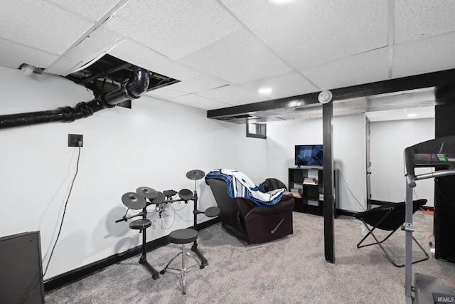 workout room featuring carpet, a drop ceiling, and baseboards