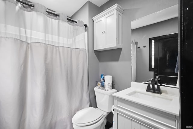 full bath featuring curtained shower, vanity, and toilet