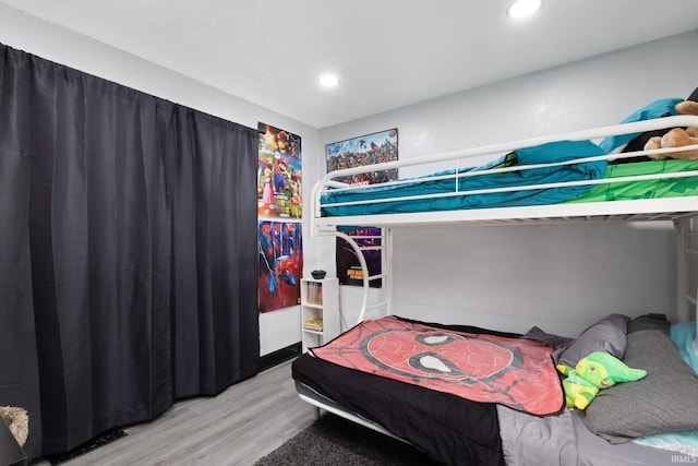 bedroom featuring wood finished floors and recessed lighting