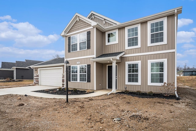 view of front of home with concrete driveway and an attached garage