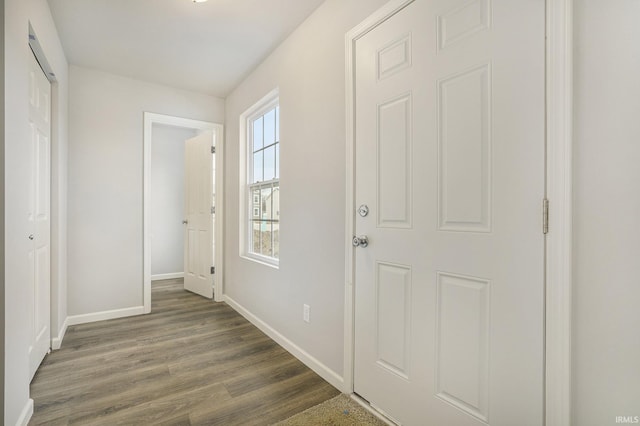 entryway with baseboards and dark wood-style flooring