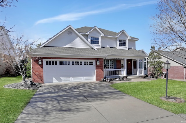 traditional-style home with brick siding, a porch, concrete driveway, an attached garage, and a front yard