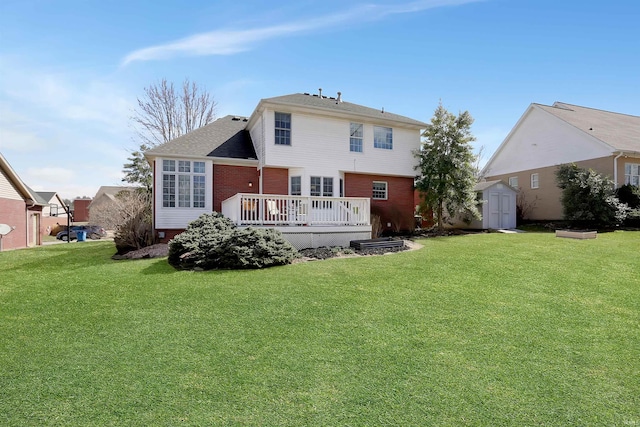 rear view of property featuring a yard, a shed, a deck, and an outdoor structure