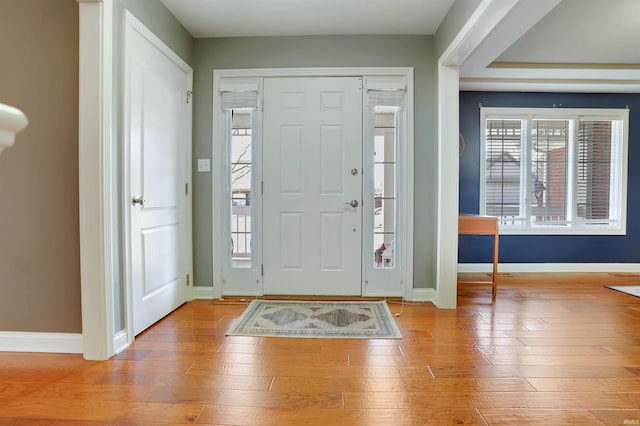 foyer featuring wood finished floors and baseboards