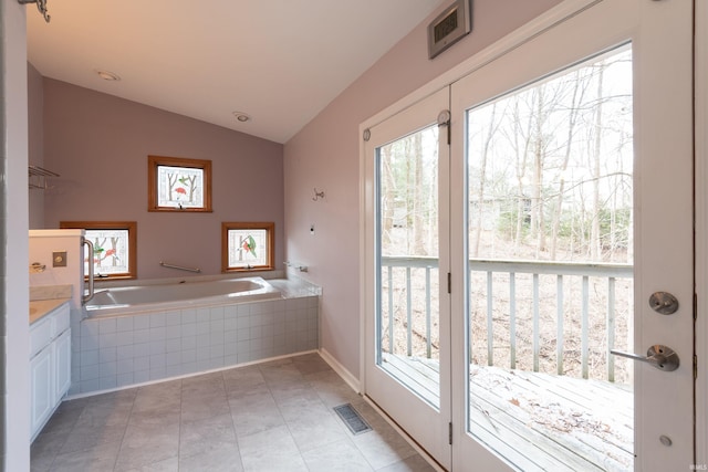 doorway to outside featuring lofted ceiling, light tile patterned floors, and visible vents