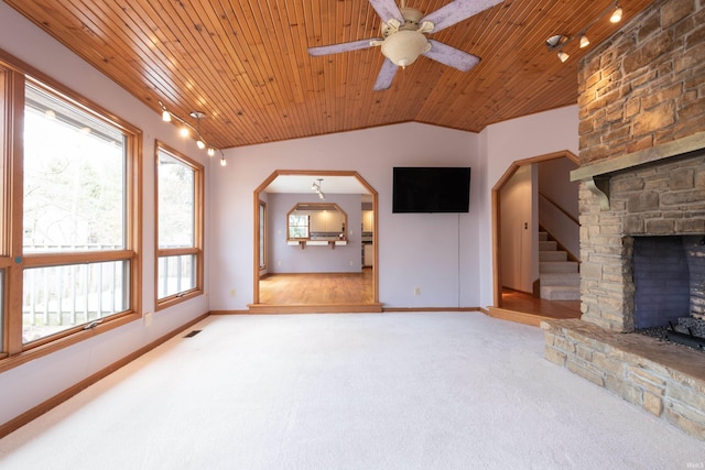 unfurnished living room featuring stairs, carpet floors, vaulted ceiling, wooden ceiling, and a fireplace