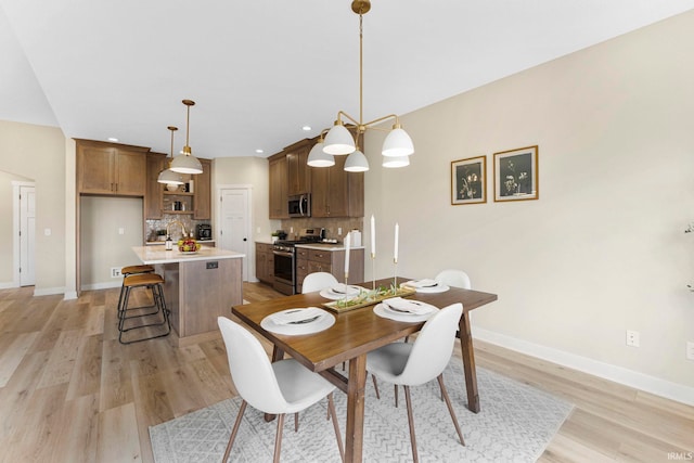 dining space with light wood-style floors, recessed lighting, and baseboards