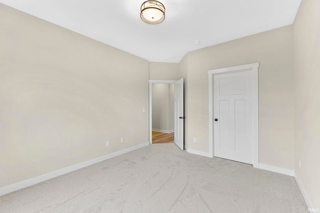 unfurnished bedroom featuring carpet and baseboards