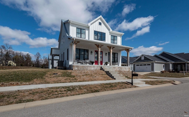 modern farmhouse featuring driveway, central AC, covered porch, board and batten siding, and an attached garage