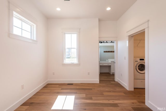 unfurnished bedroom with recessed lighting, baseboards, a spacious closet, and light wood finished floors