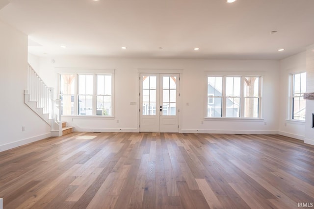 interior space with recessed lighting, wood finished floors, and stairs