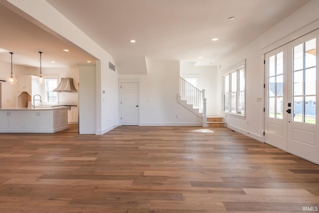 interior space with recessed lighting, visible vents, stairway, and light wood finished floors