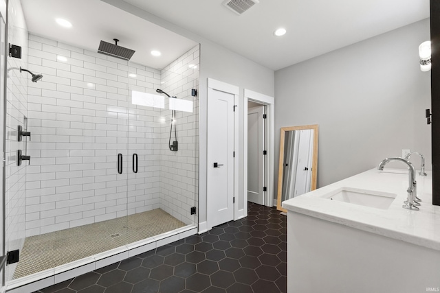 bathroom featuring recessed lighting, visible vents, a sink, a shower stall, and tile patterned floors