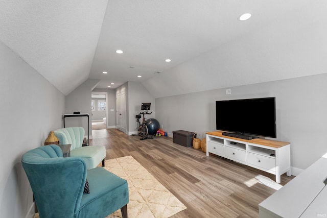 living area with lofted ceiling, recessed lighting, baseboards, and light wood-style floors