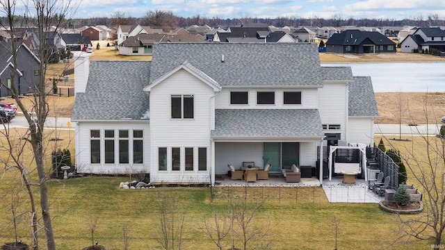 back of property with a yard, a residential view, an outdoor hangout area, and a patio