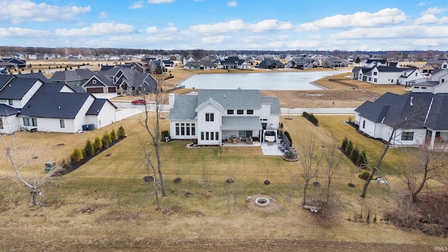 birds eye view of property featuring a water view and a residential view