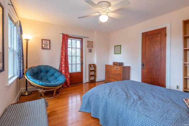 bedroom with light wood-type flooring, ceiling fan, and baseboards