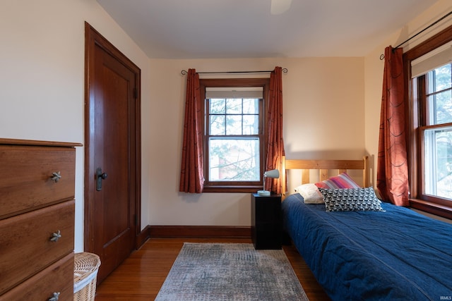 bedroom featuring baseboards and wood finished floors