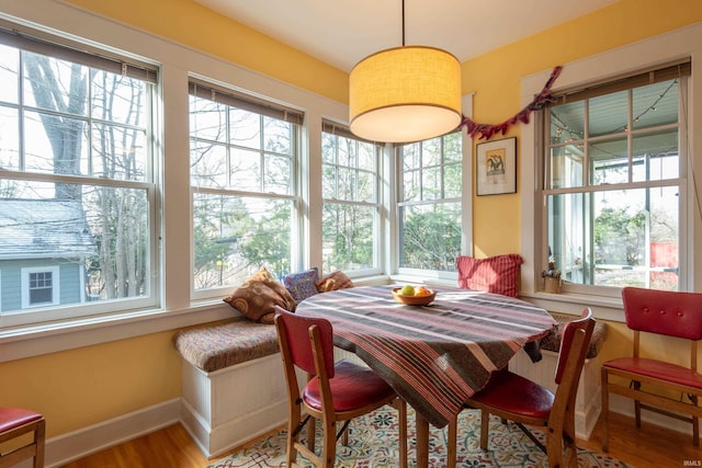 dining area with wood finished floors and baseboards