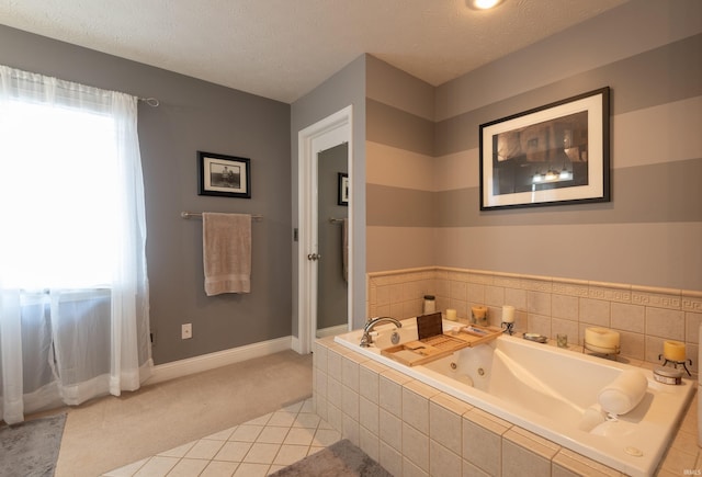 bathroom featuring tile patterned floors, plenty of natural light, a whirlpool tub, and a textured ceiling