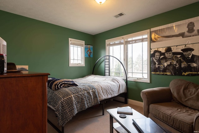 bedroom with carpet, visible vents, and baseboards