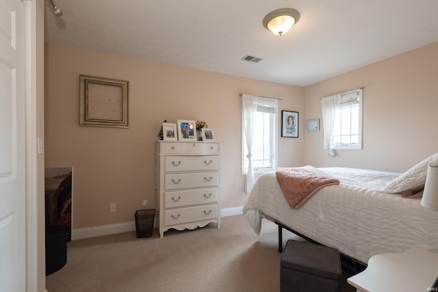 bedroom featuring visible vents, carpet floors, and baseboards