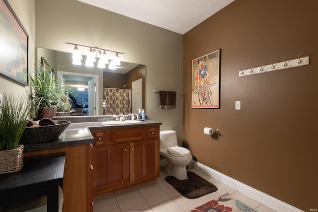 bathroom featuring vanity, baseboards, tile patterned flooring, curtained shower, and toilet