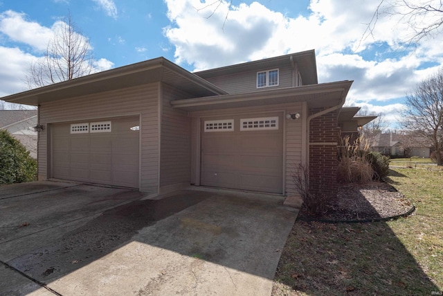 view of front of property with an attached garage and concrete driveway