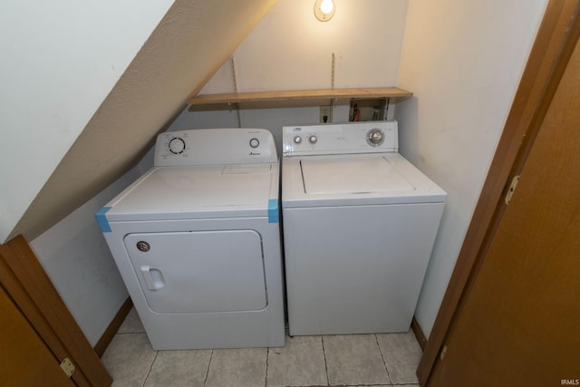 clothes washing area with laundry area, separate washer and dryer, and light tile patterned flooring