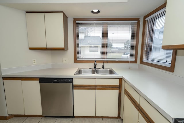 kitchen featuring a sink, light countertops, stainless steel dishwasher, and recessed lighting