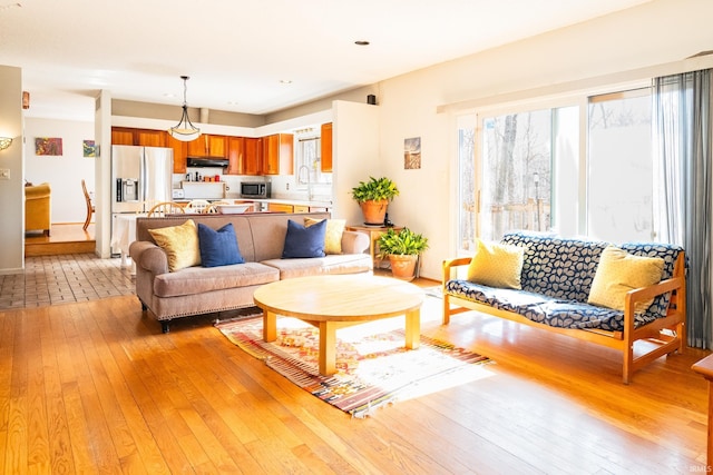 living room featuring light wood-type flooring and baseboards