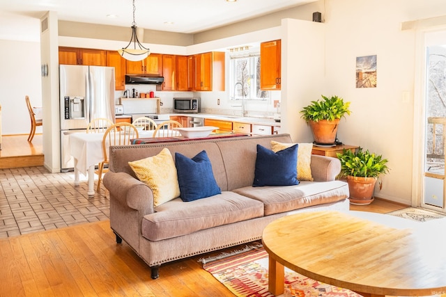 living room featuring light wood-style flooring and baseboards