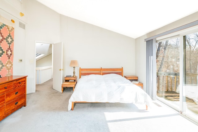 carpeted bedroom featuring access to outside, visible vents, and vaulted ceiling