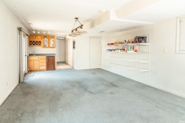 garage with a sink and baseboards