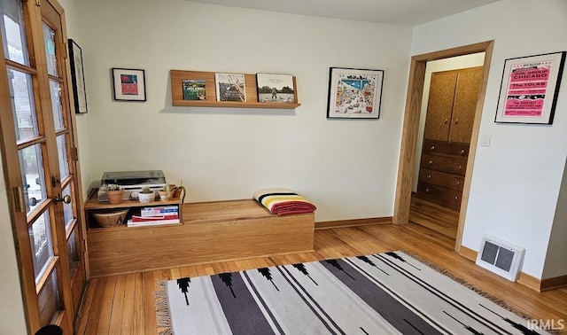 office area with visible vents, baseboards, and wood finished floors