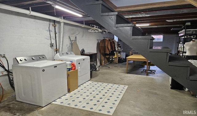 basement featuring stairway and washing machine and clothes dryer