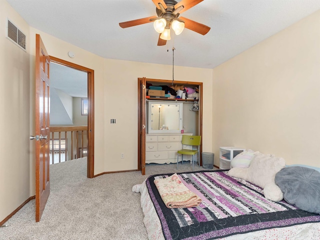 bedroom featuring carpet floors, a closet, visible vents, ceiling fan, and baseboards