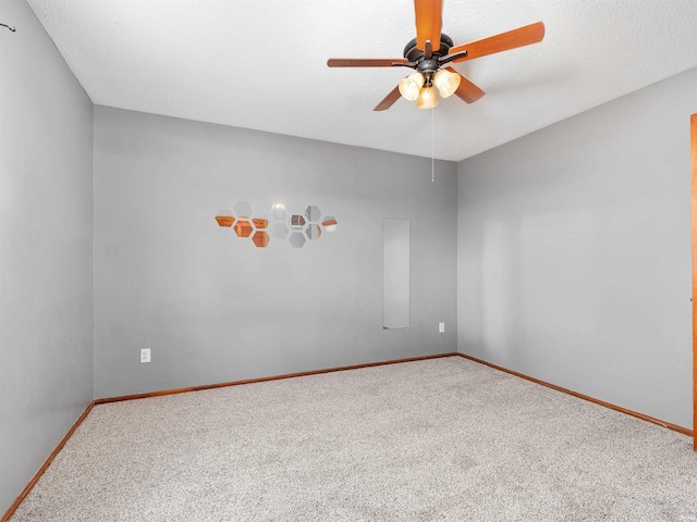 carpeted empty room with ceiling fan, baseboards, and a textured ceiling