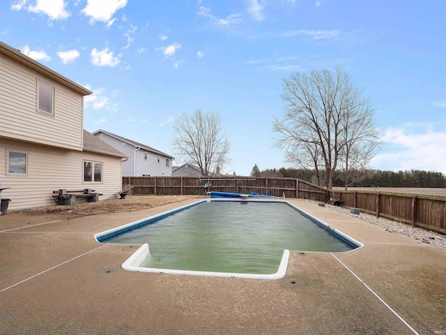 view of swimming pool featuring a fenced in pool, a patio area, and a fenced backyard